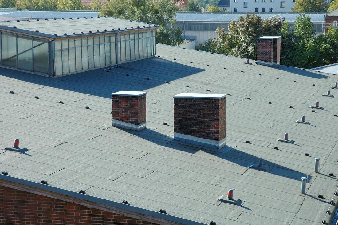 Low-slope roof surface under repair